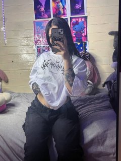 Brunette teen takes selfies while stripping to her thong on a bed